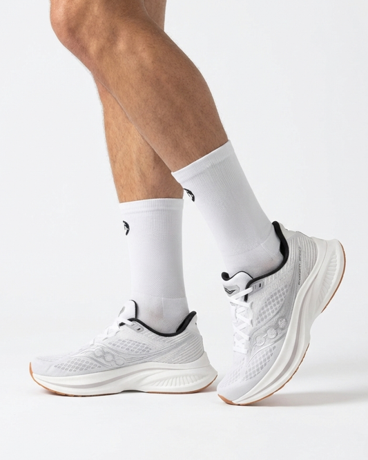 White athletic shoes and socks on a white background