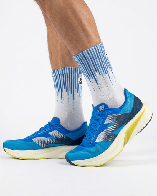 Blue running shoes with white socks on a white background