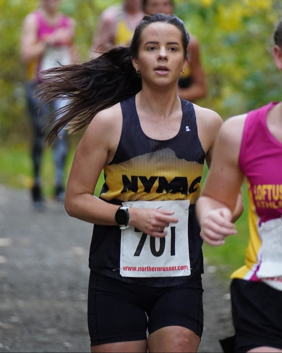 Woman running in a race with a visible race number