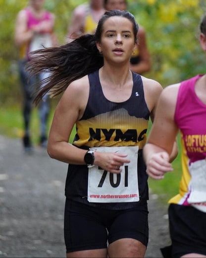 Woman running in a race with a visible race number