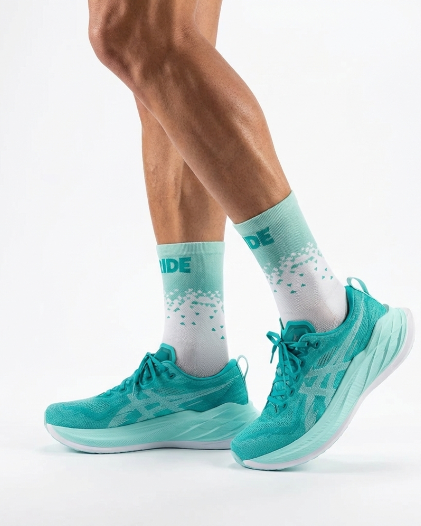 Teal running shoes and socks on a white background
