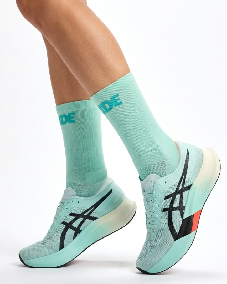 Light blue running shoes and socks with a brand logo on a white background