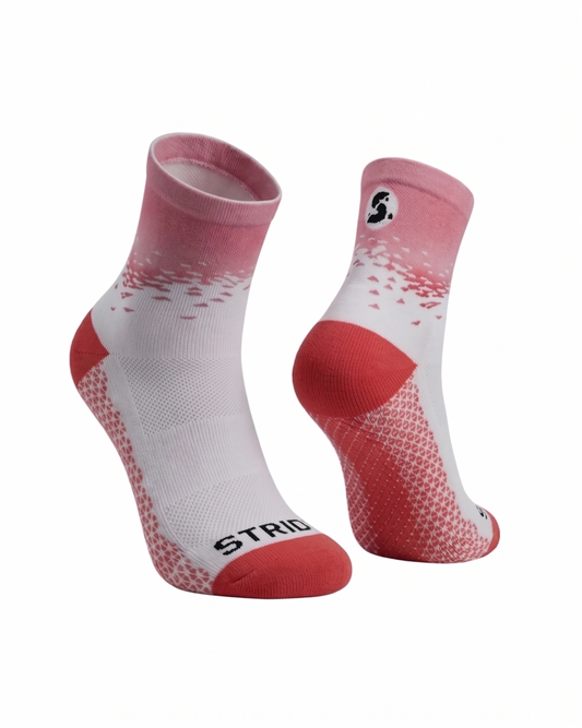 White and red socks with 'STRIDE' branding on a white background